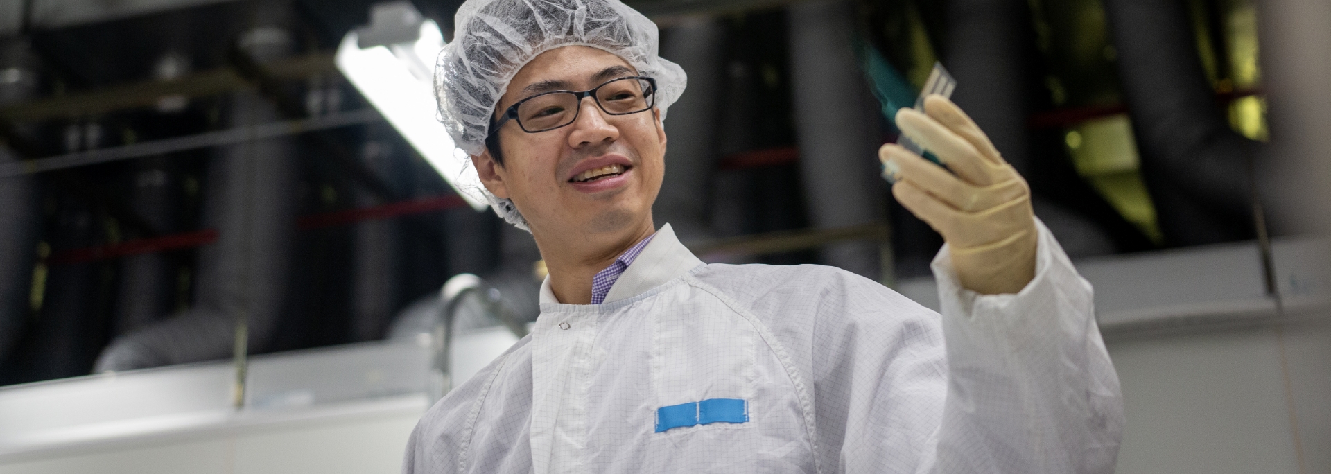 Technician holding semiconductor wafer